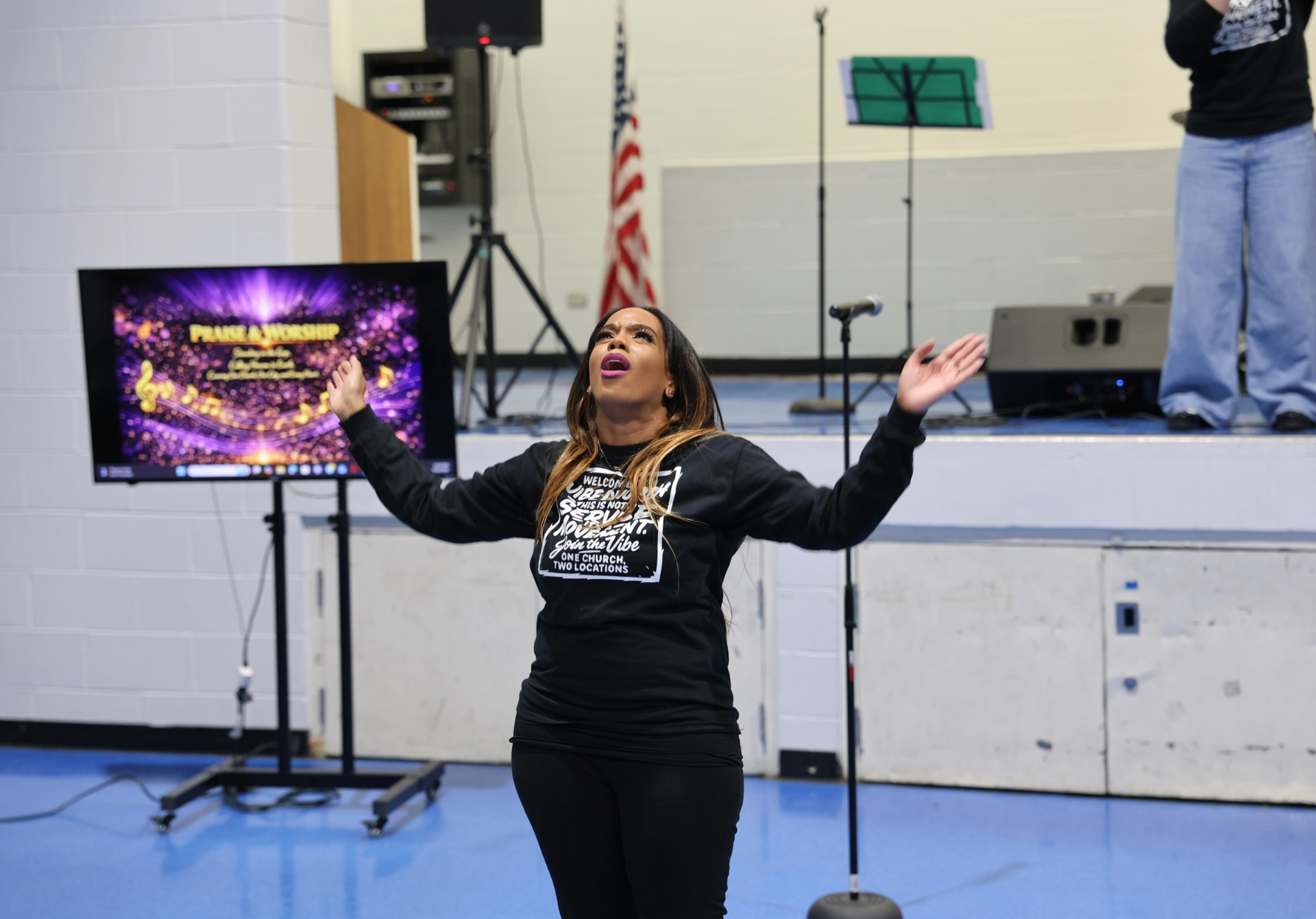 Worship leader praising with arms lifted