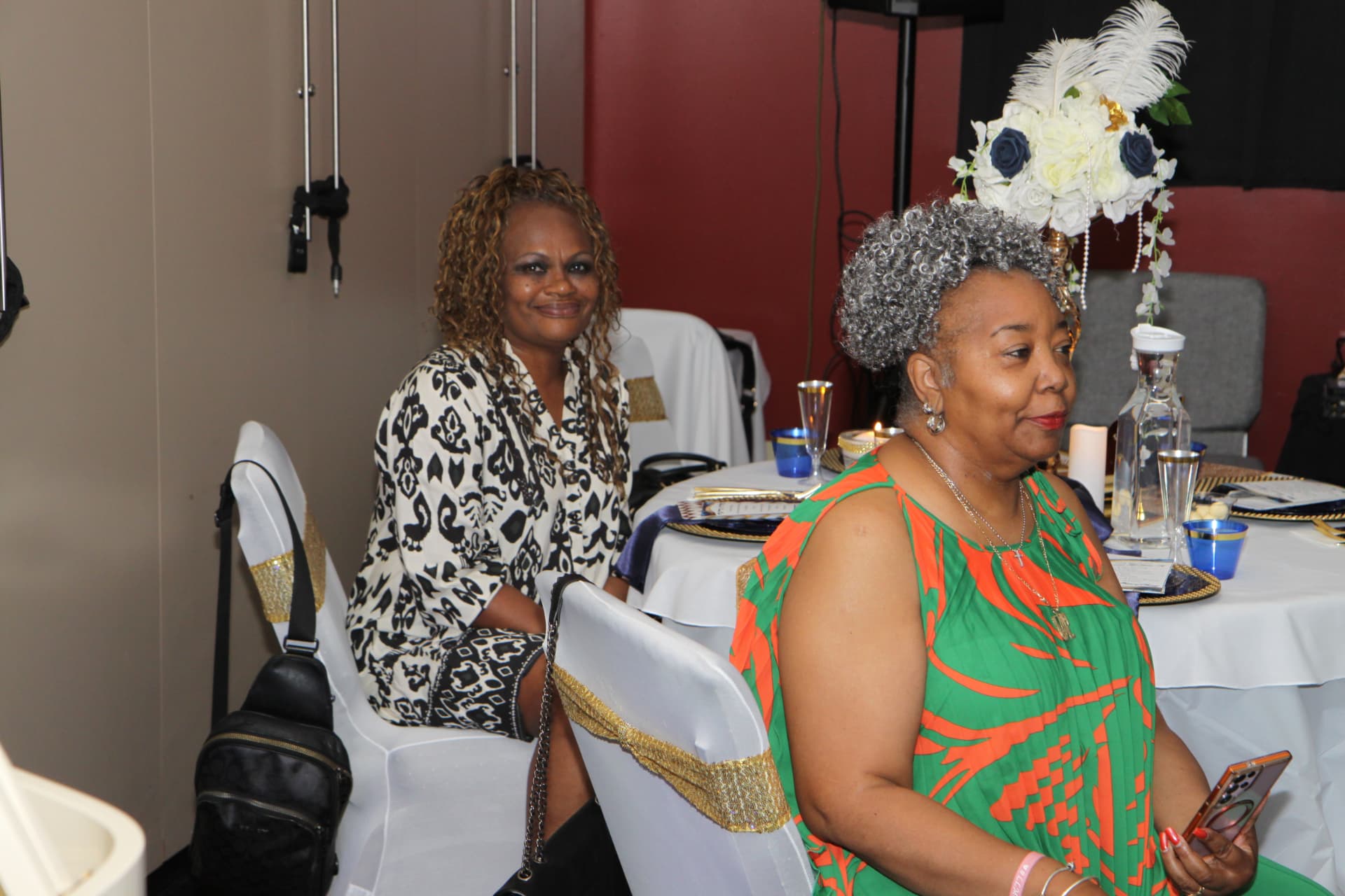 Two guests seated at a decorated table during the celebration