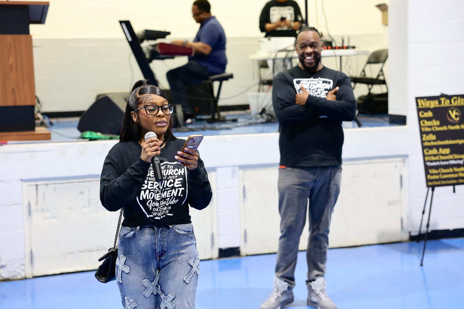 Davisha speaking into a microphone during service