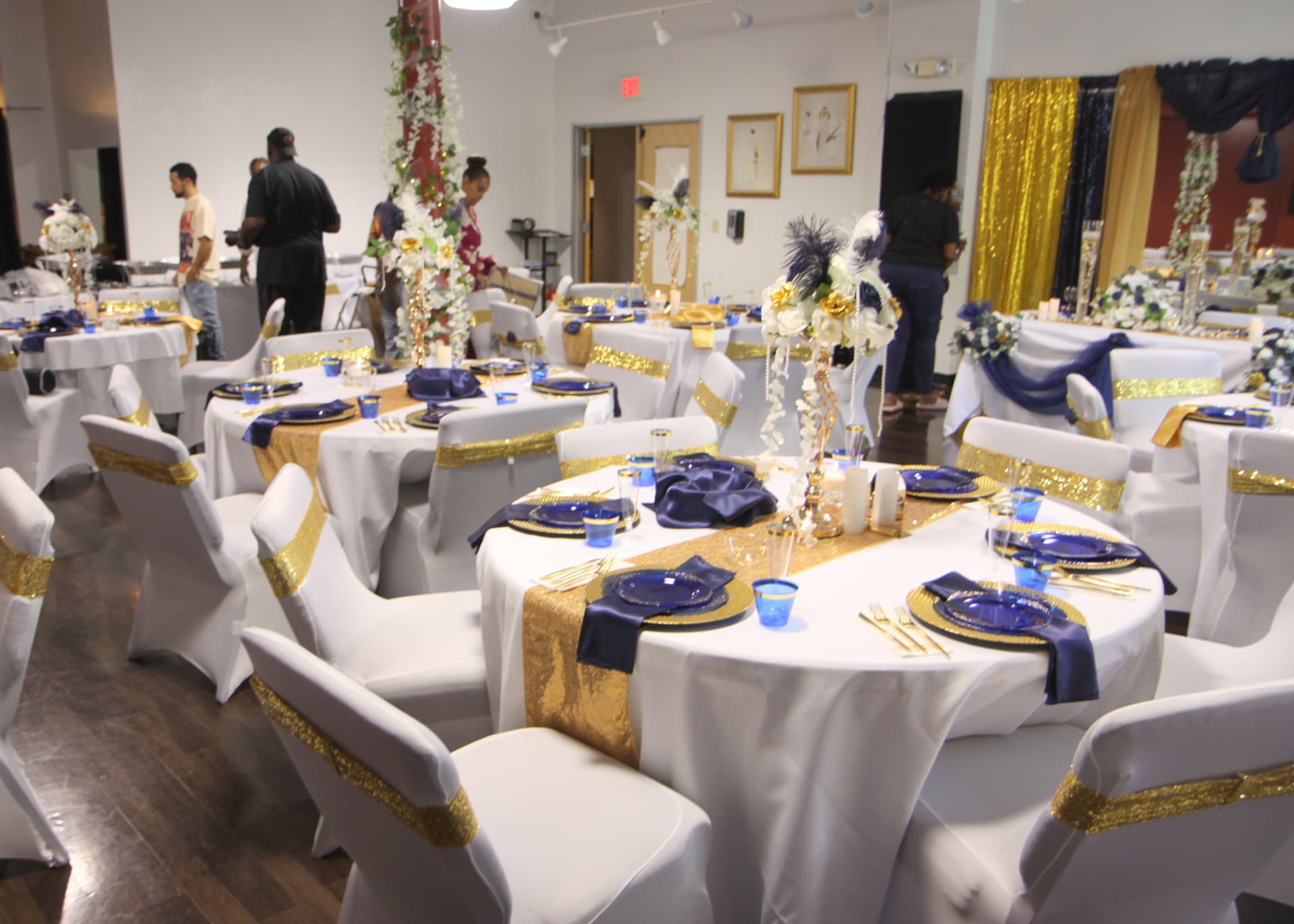 Banquet hall set with navy and gold table settings
