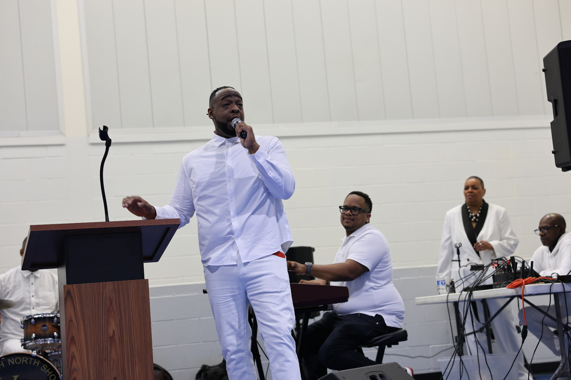 Pastor Henderson ministering in white on Pentecost Sunday