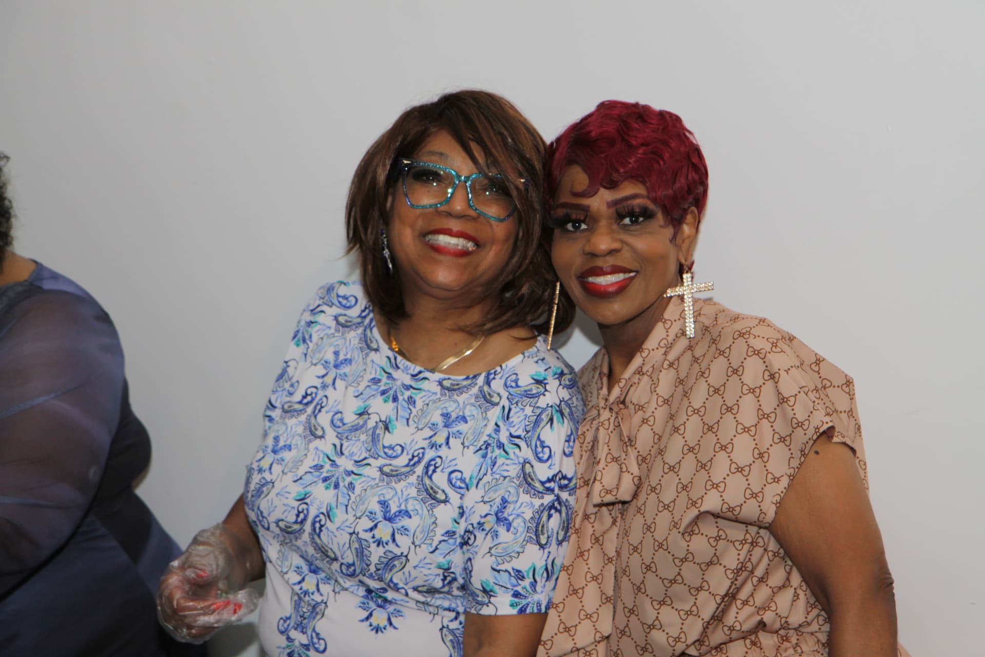 Two guests posing together at the birthday celebration