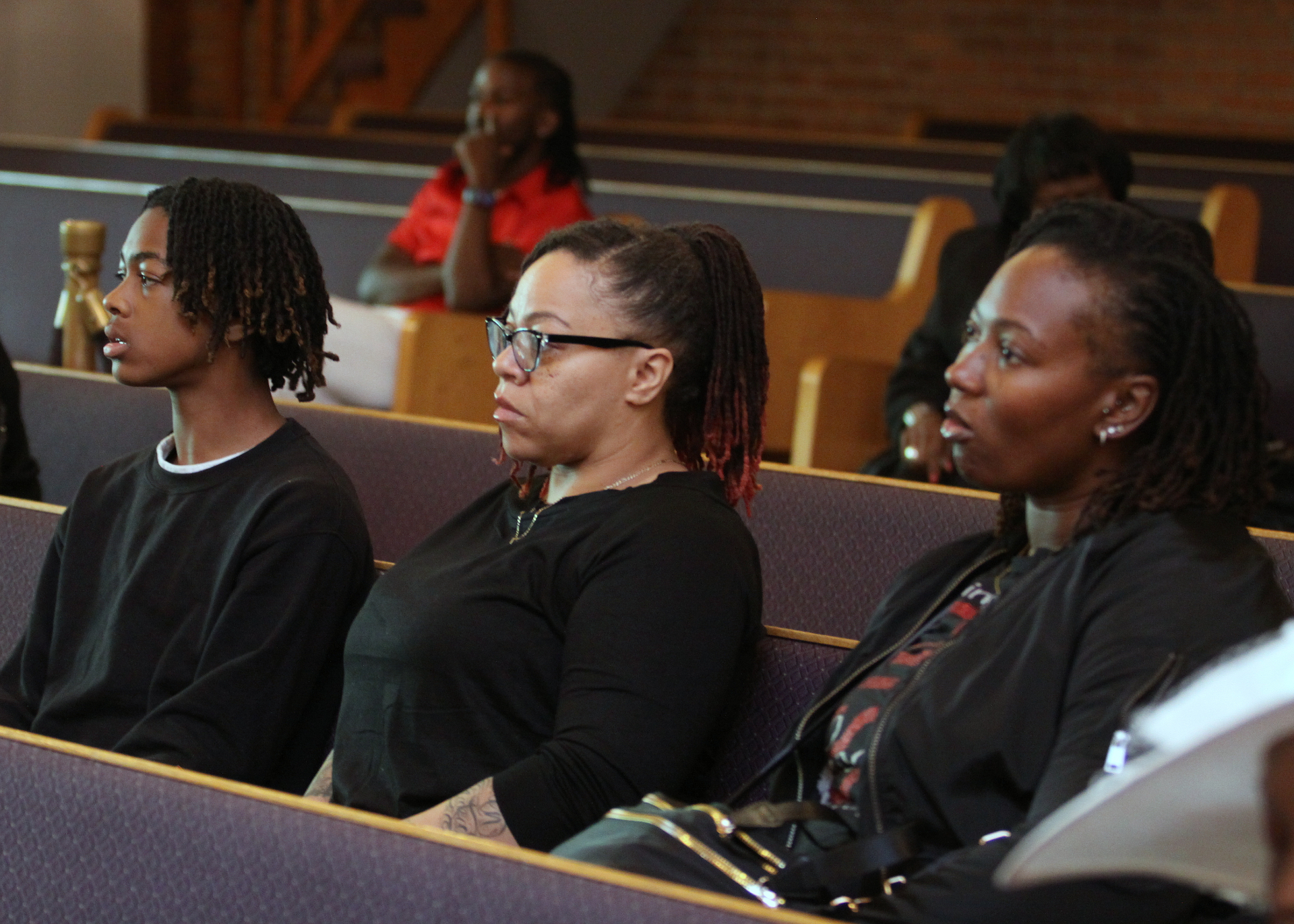 Family seated together during the baptism service