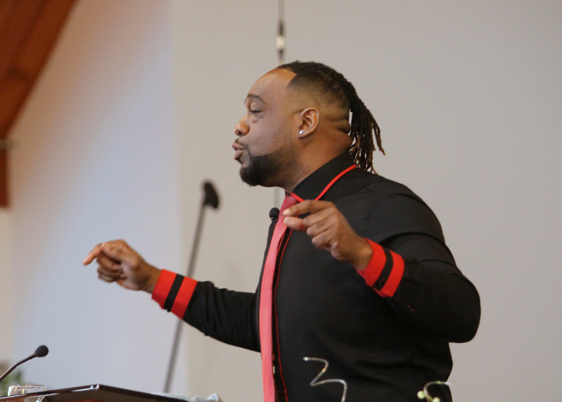 Minister preaching passionately during baptism service