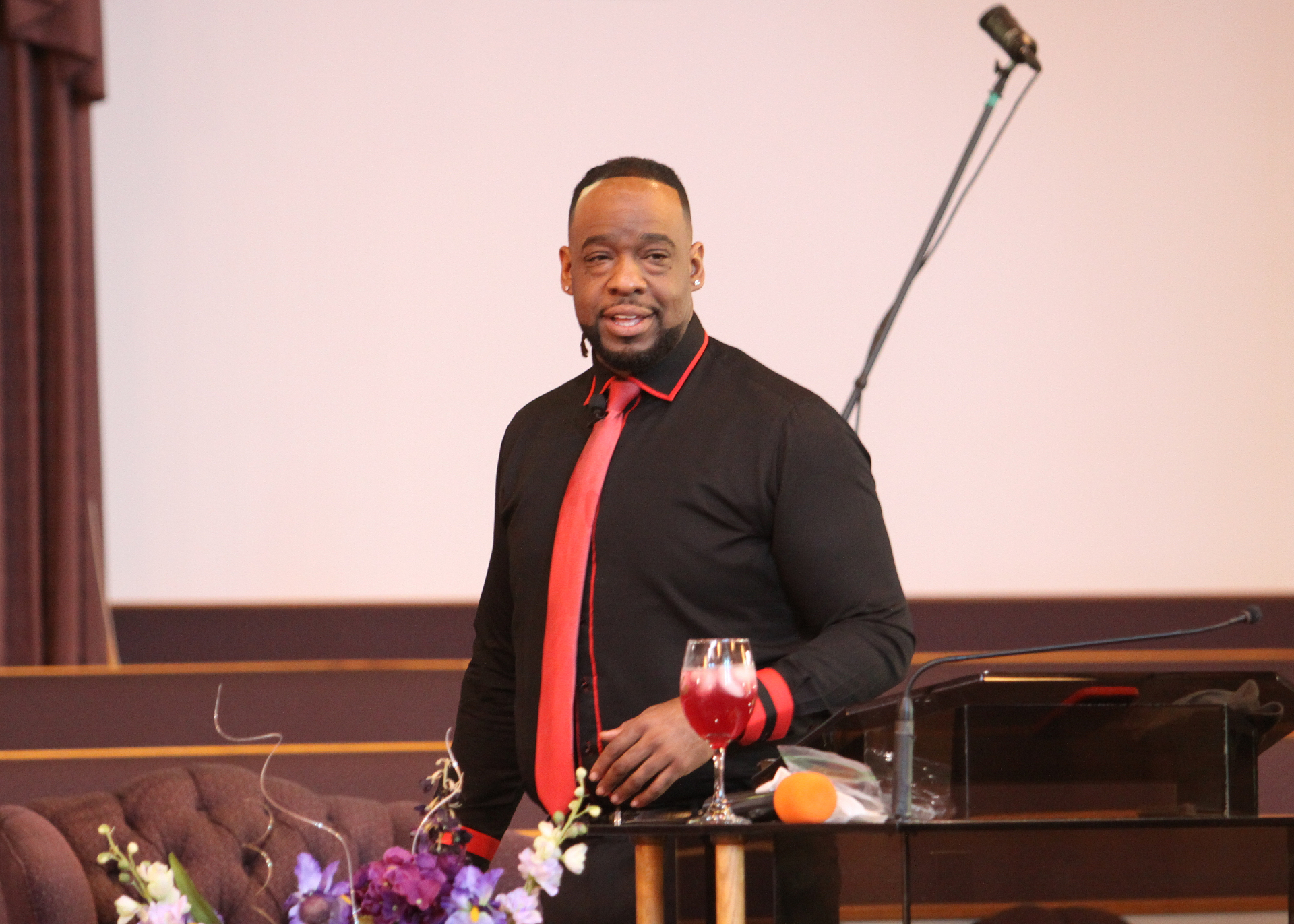 Pastor Henderson standing beside the pulpit during service