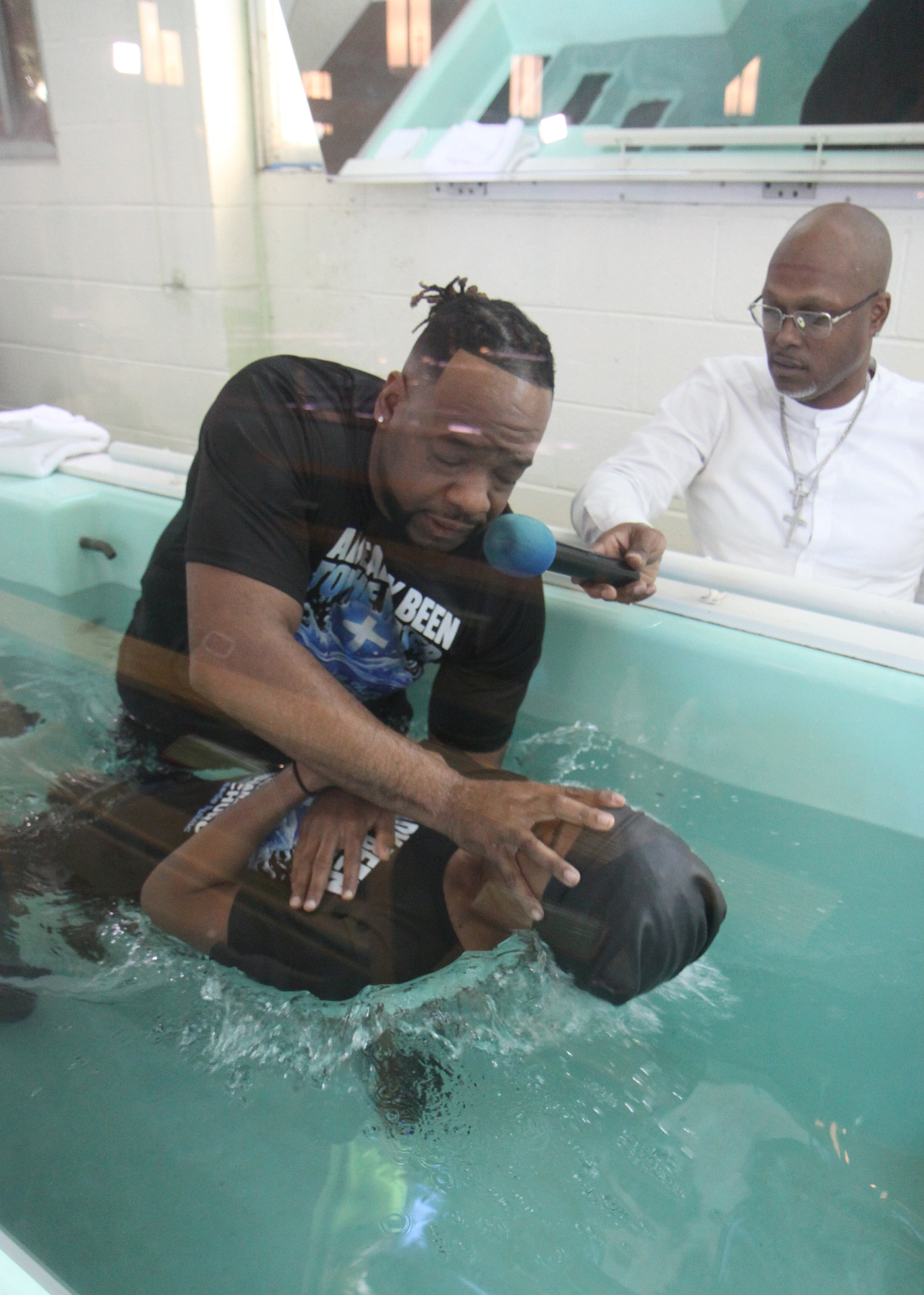 Pastor Henderson immersing a believer in baptism