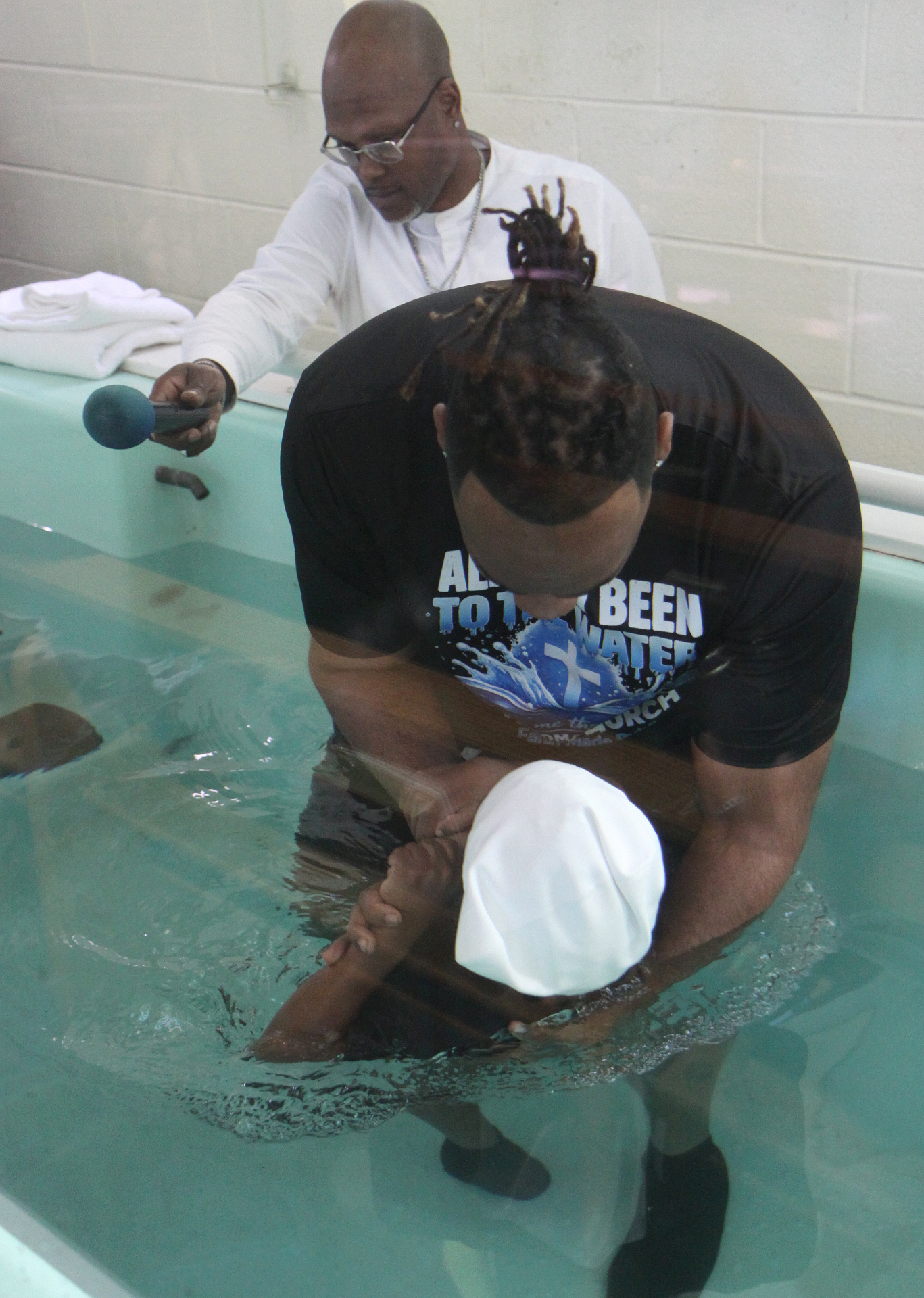Pastor Henderson baptizing a young believer