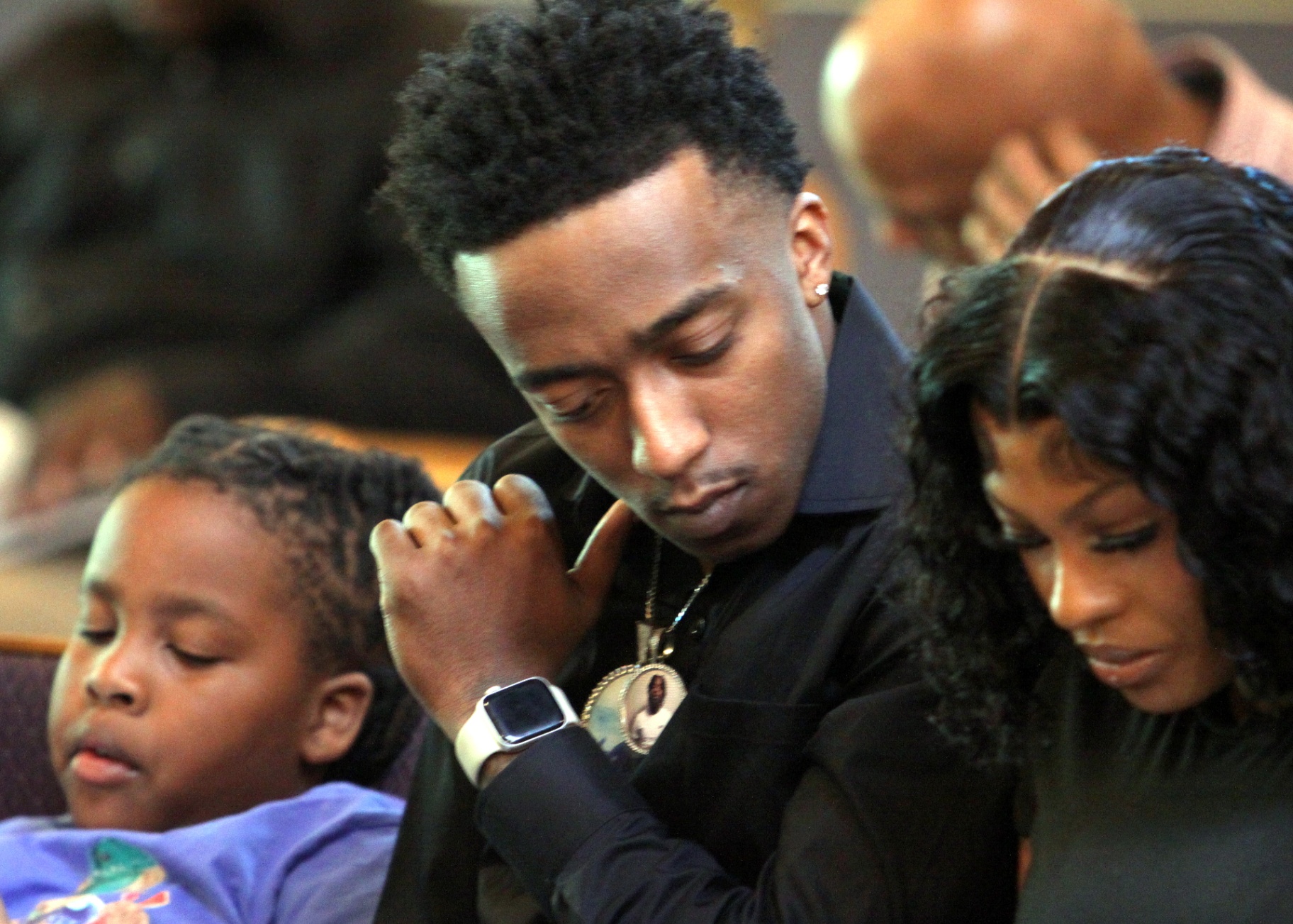 Family bowed together in prayer