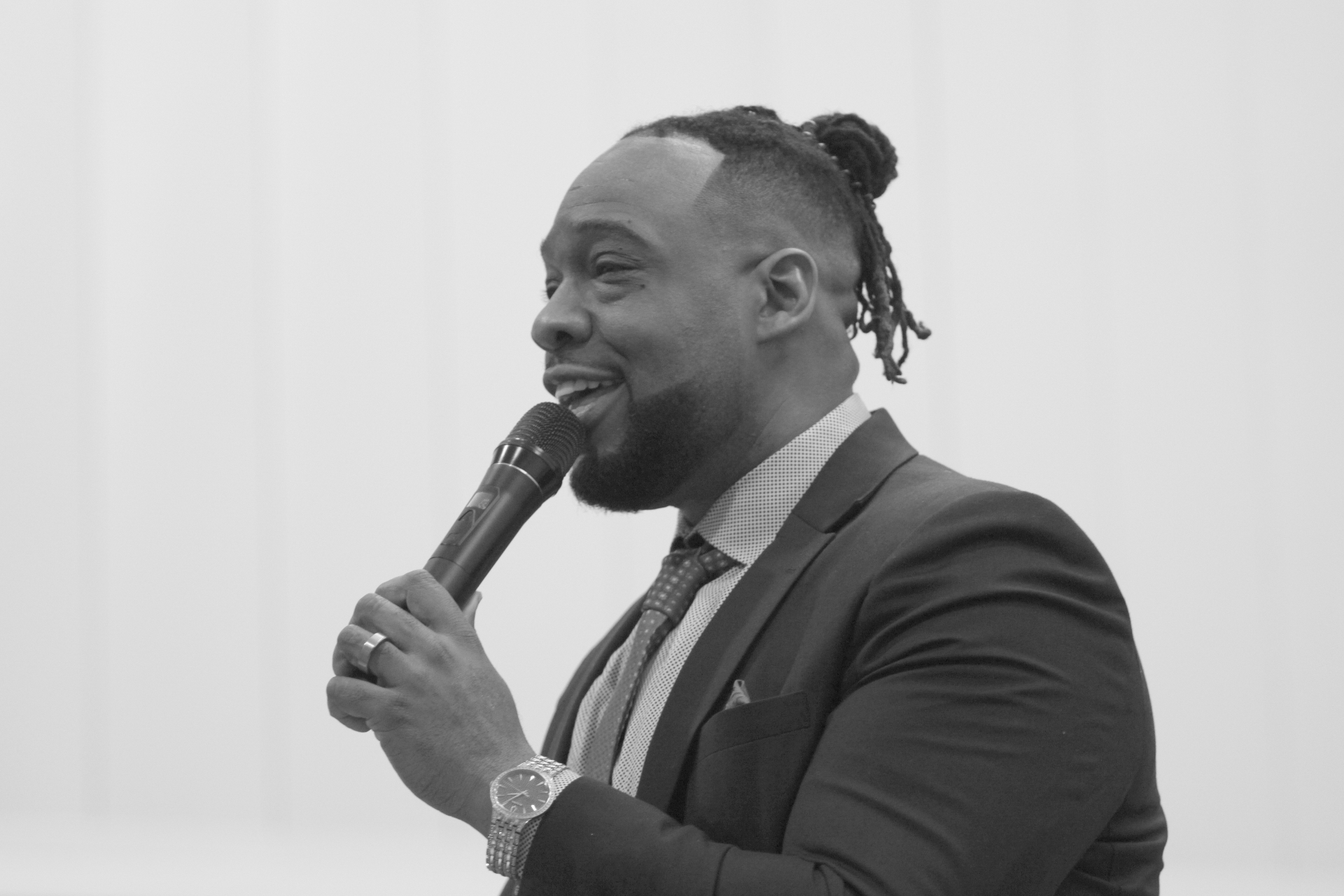 Pastor Henderson speaking into a microphone