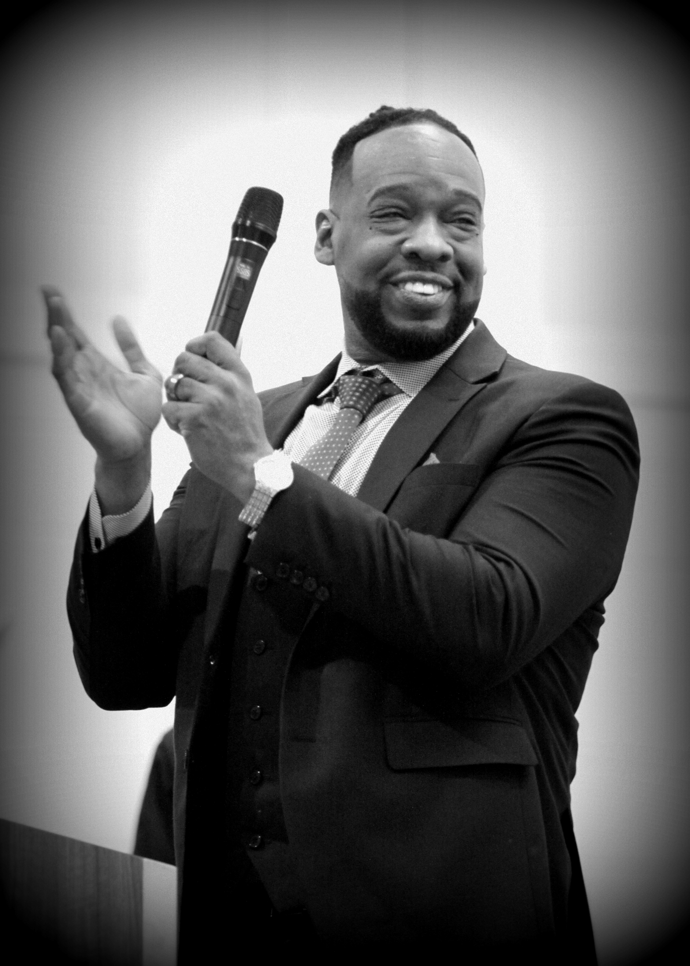 Pastor Henderson praising with microphone in hand