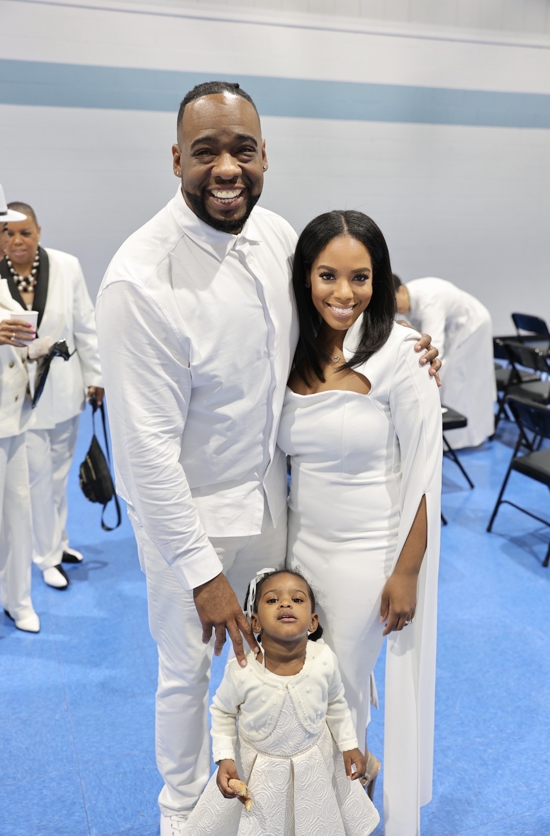 Family of three dressed in white