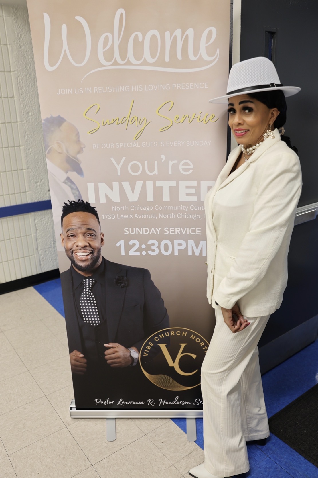 Pastor's mother by the Welcome banner