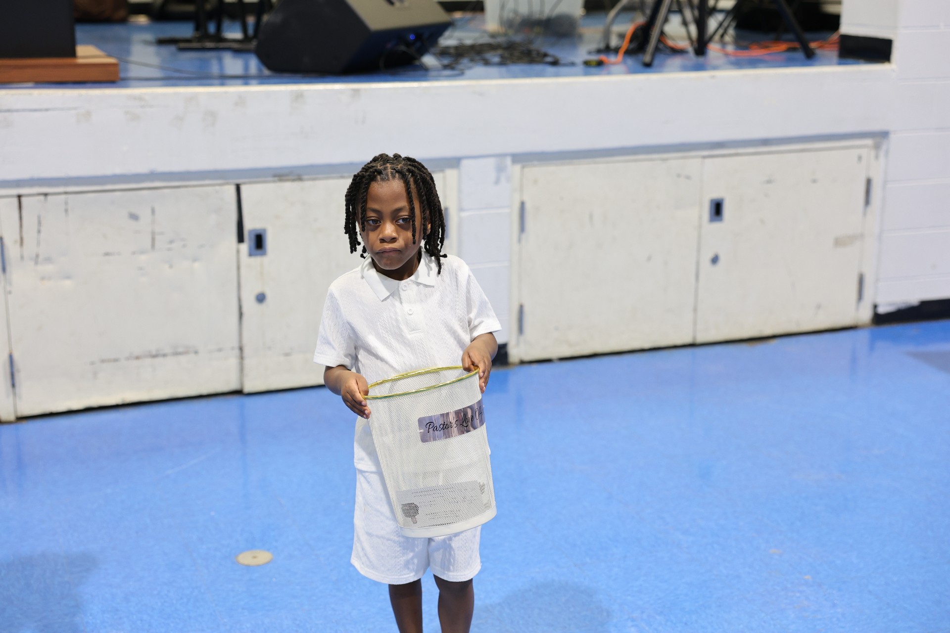 Young boy holding the Pastor's Love Offering basket