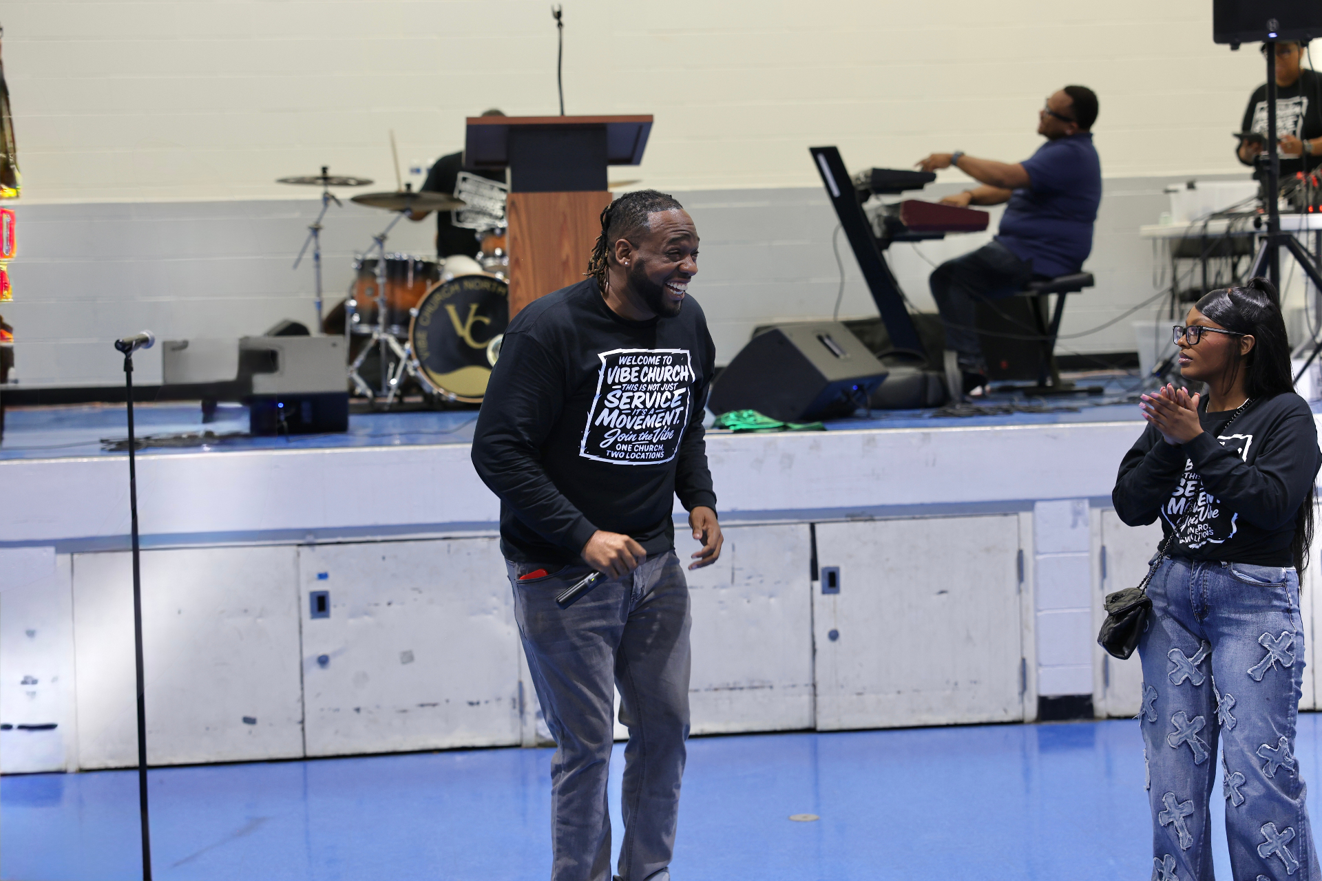 Pastor laughing alongside a young adult in ministry